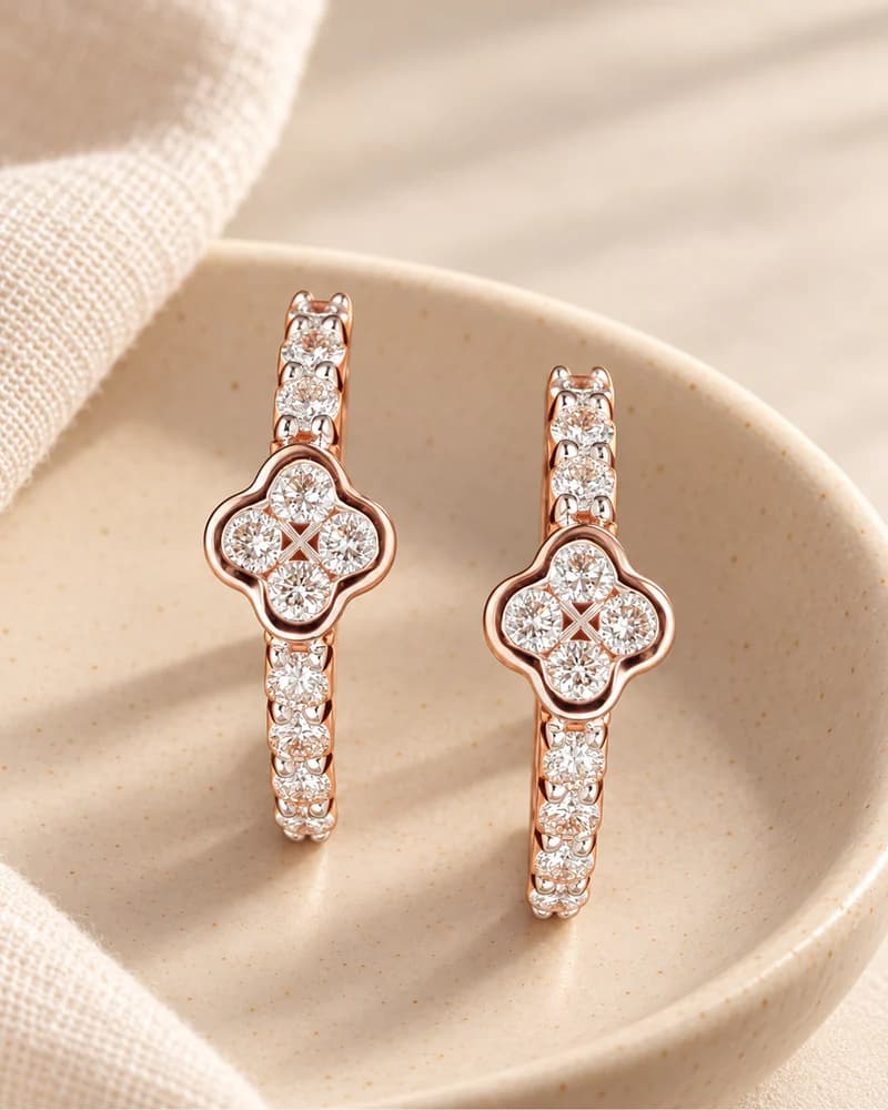 Lab-grown diamond bali earrings in rose gold resting in a dish